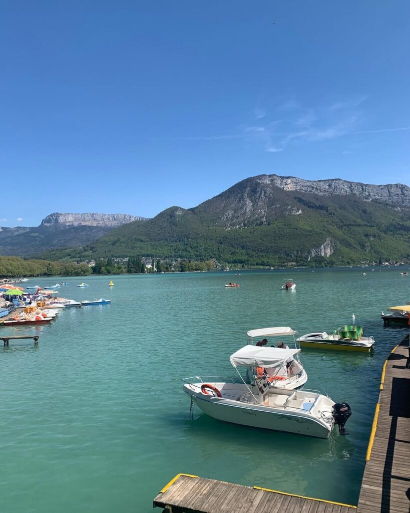 A serene view of Lac Montriond, with its turquoise waters reflecting the surrounding mountains. Morzine travel guide and weed laws.