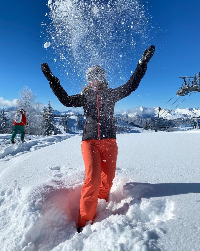 A skier descending a pristine slope with Morzine’s chalet-dotted valley below.