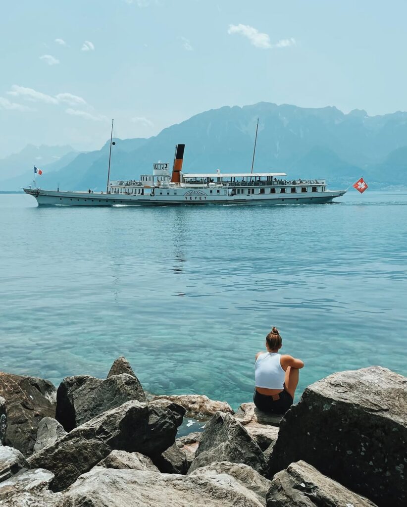 A sunset view of Montreux travel guide and weed laws, with the lake reflecting the warm hues of the sky