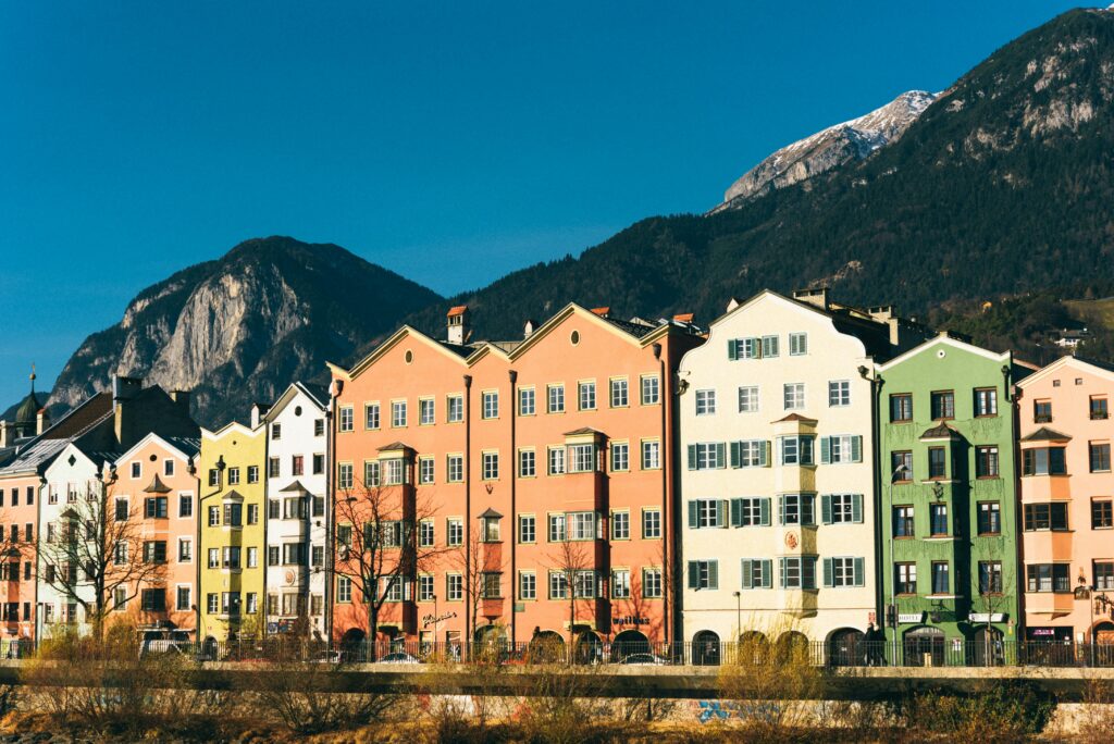 A cozy hostel room with a view of Innsbruck’s mountain landscape.