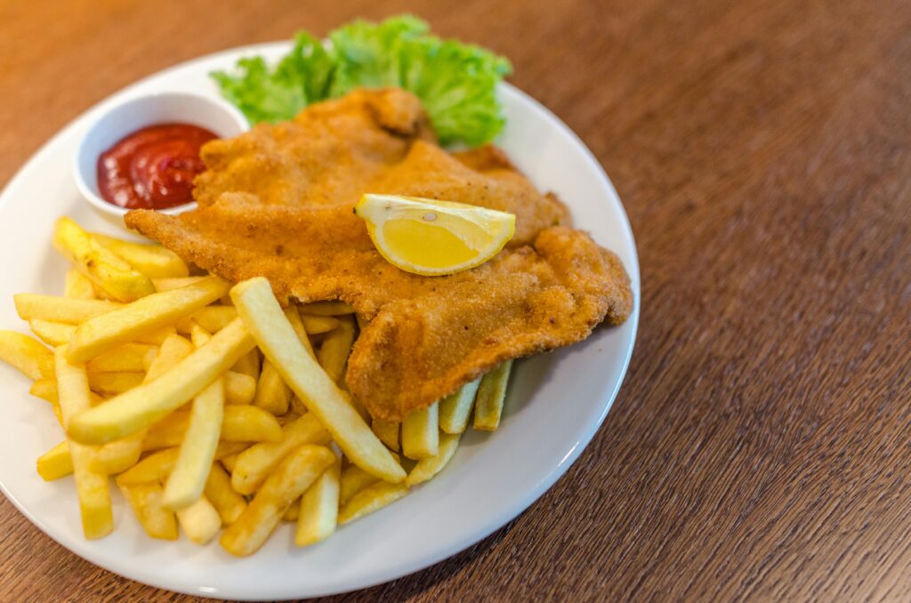 Wiener Schnitzel with a lemon wedge and potato salad